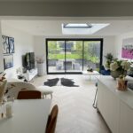 Interior of a Vivid Green SIPs house extension modern kitchen with breakfast nook and living area